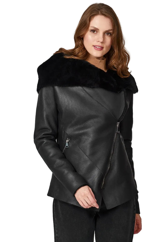 Woman wearing a black leather jacket with fur collar on a white background
