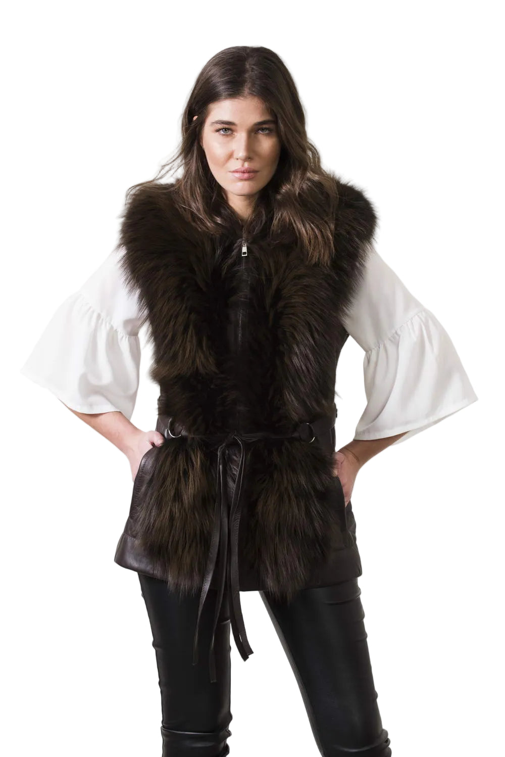 Woman wearing a dark fur vest over a white shirt on a plain background