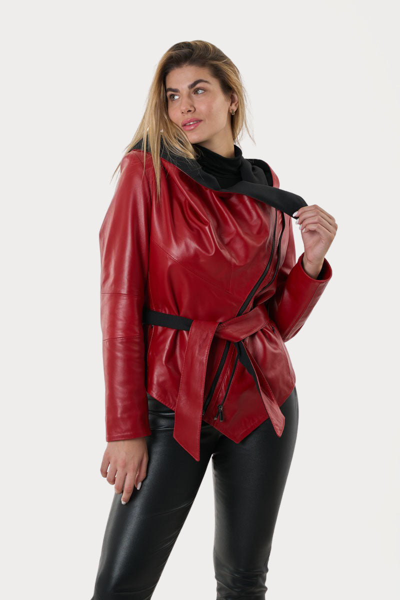 Woman wearing a red leather jacket and black pants on a white background
